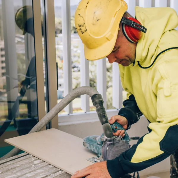 Construction site worker in yellow suit